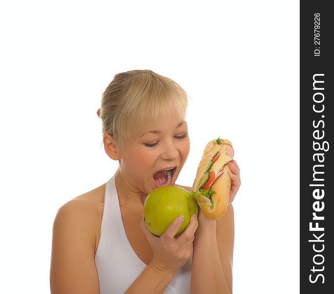 Slim woman choosing between apple and hamburger. isolated on white