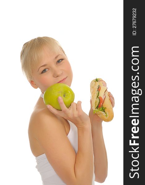 Slim woman choosing between apple and hamburger. isolated on white