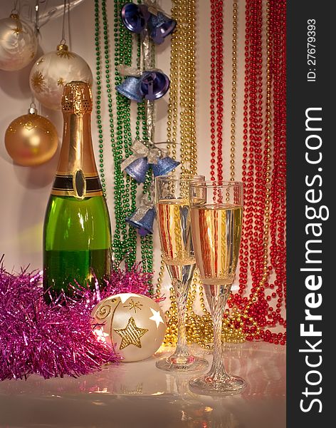New Year decorations with two glasses and bottle of champagne