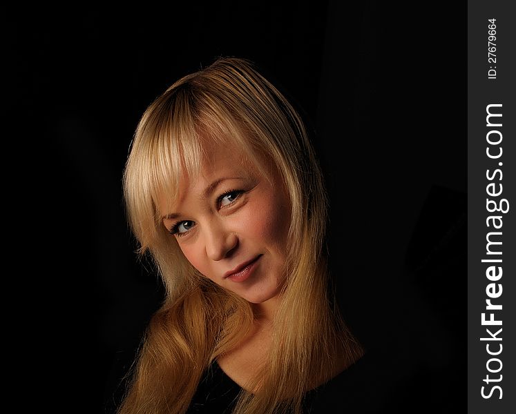 Young blond hair woman portrait   on dark background