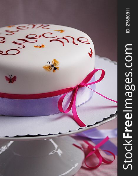 Celebration cake decorated with bright hand painting and satin ribbons. Celebration cake decorated with bright hand painting and satin ribbons