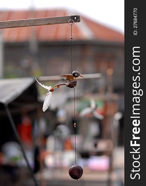 Bird vane mobile. Handmade from coconut, dried fruit and feathers.