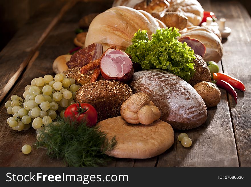 Healthy fruits and vegetables near bread on studio wood table. Healthy fruits and vegetables near bread on studio wood table