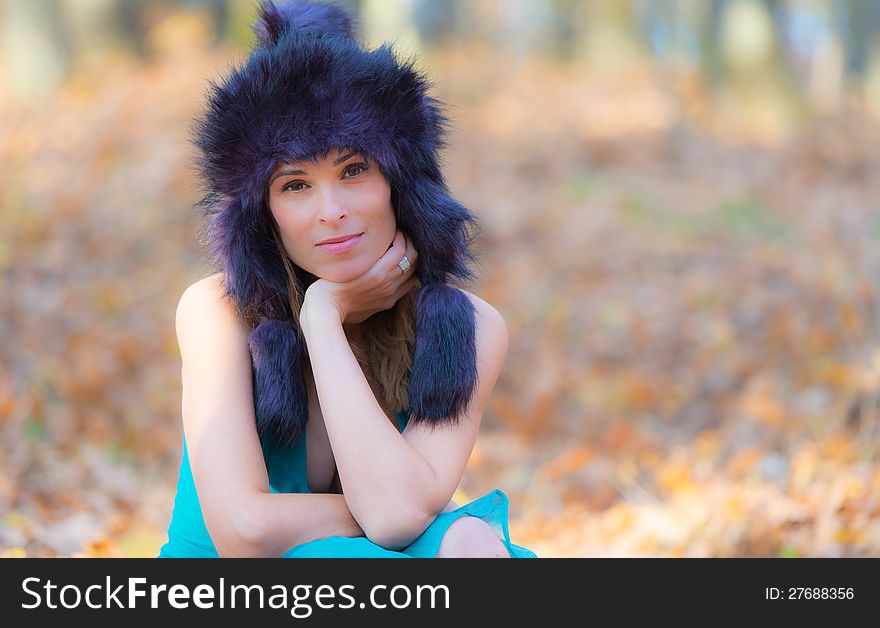 Beautiful elegant woman standing in a park in autumn. Beautiful elegant woman standing in a park in autumn