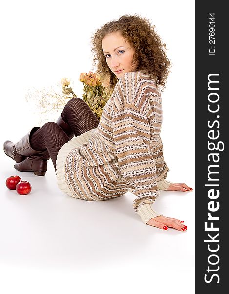 Girl sits comfortably in a sweater isolated on white background. Girl sits comfortably in a sweater isolated on white background