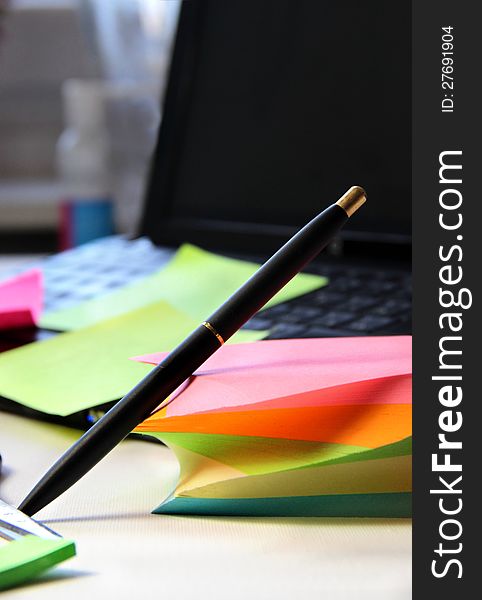 Mix of office stationery - computer, pen, note papers