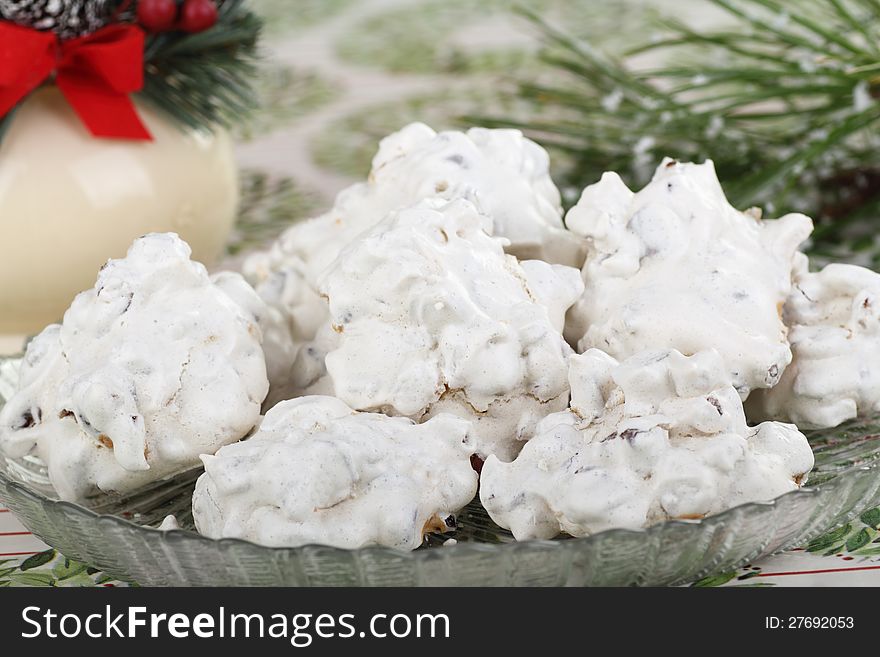 White cookies on a plate with Christmas decorations. White cookies on a plate with Christmas decorations