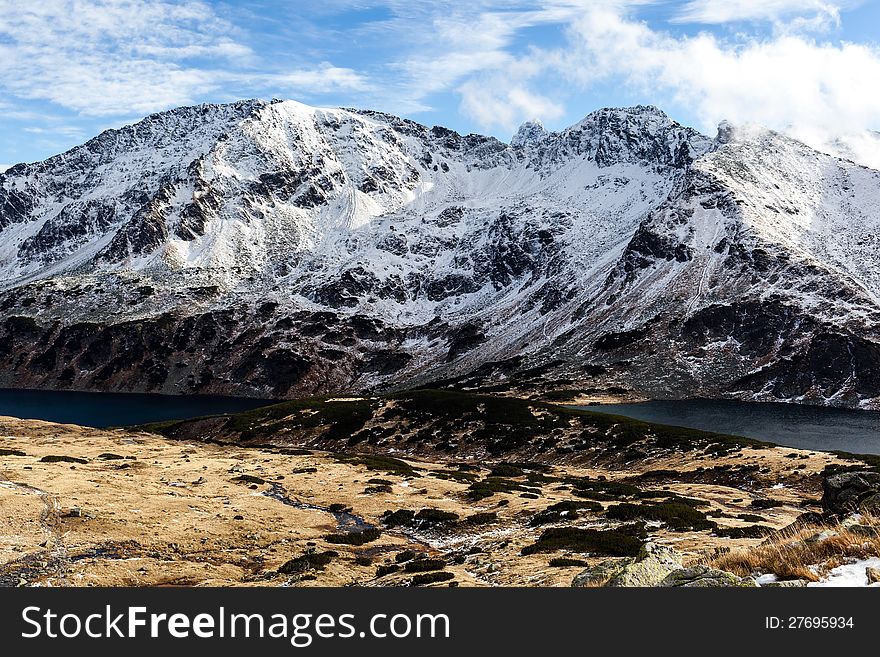 Mountains landscape in winter in Tatras. Mountain ridge over blue sunny sky, Poland. Mountains landscape in winter in Tatras. Mountain ridge over blue sunny sky, Poland