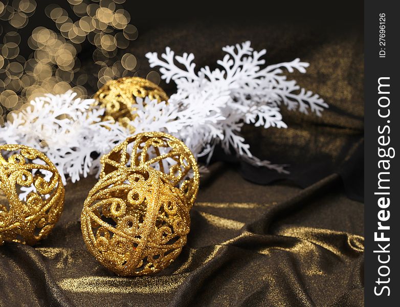 Golden Christmas balls on shiny fabric and white decoration branch. Golden Christmas balls on shiny fabric and white decoration branch