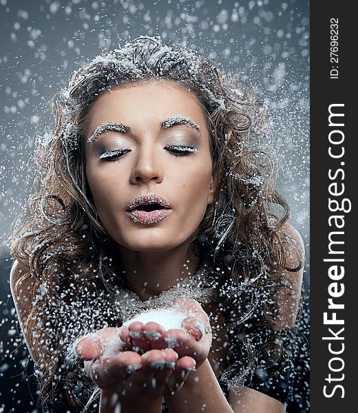 Portrait of young woman with snow make-up. Christmas snow queen