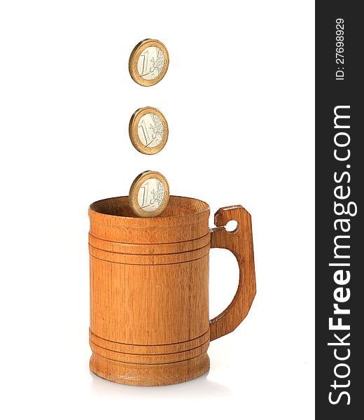 Wooden mug and coins isolated over white. Wooden mug and coins isolated over white.