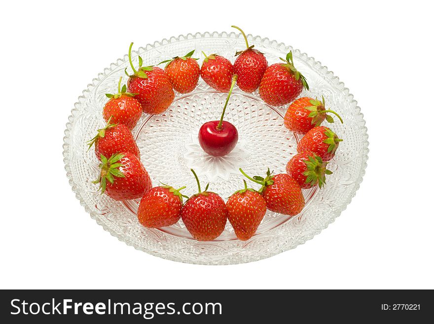 Strawberries and a cherry on a glass dish, isolated on white background. Strawberries and a cherry on a glass dish, isolated on white background