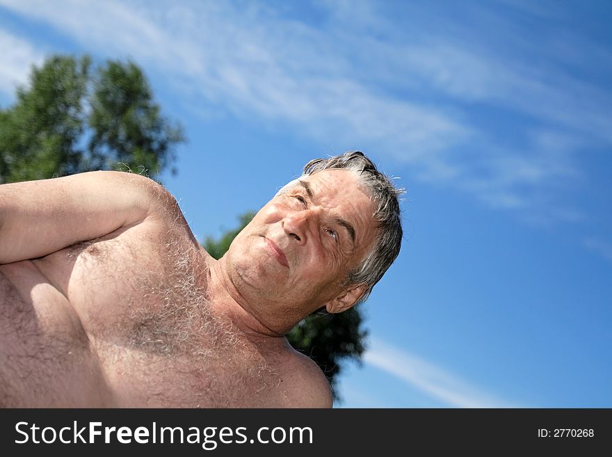 Grey man meditates outdoor in the summer