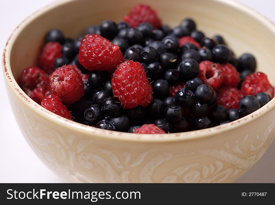 Bowl of fresh forest raspberry and blueberry