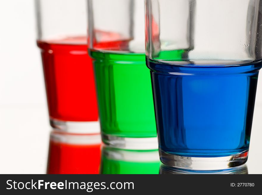 Red green blue coloured liquid in three glasses