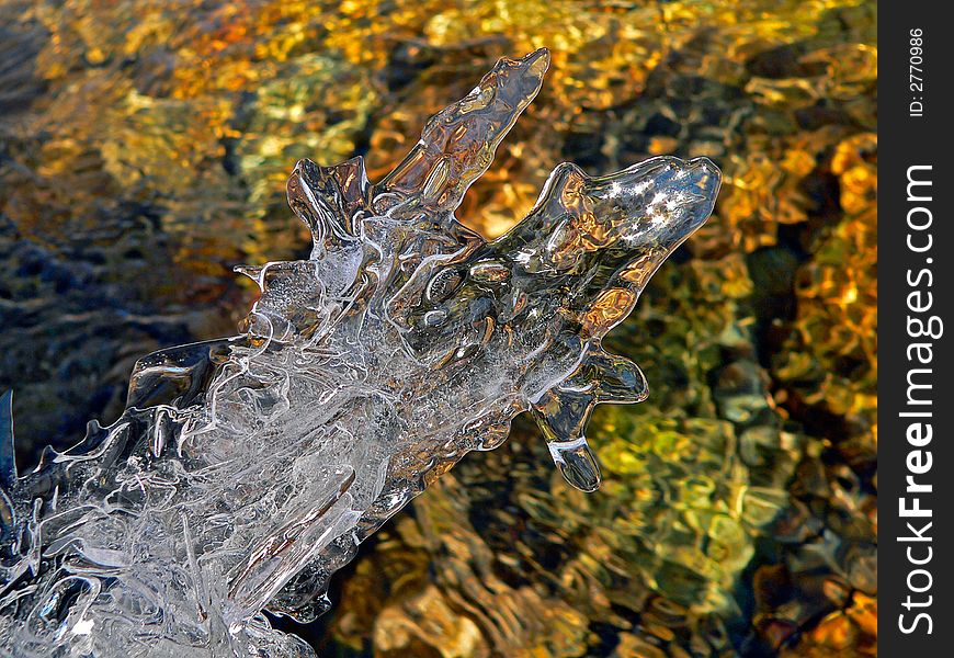 A close up of the fancy melting ice abobe the flowing water. A close up of the fancy melting ice abobe the flowing water.