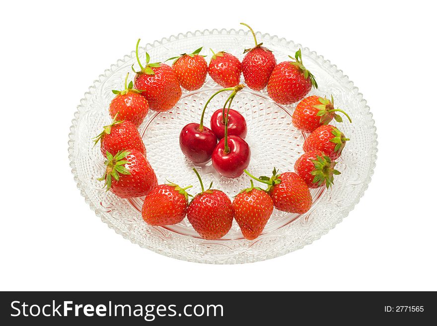 Strawberries and three cherries on a glass dish, isolated on white background. Strawberries and three cherries on a glass dish, isolated on white background