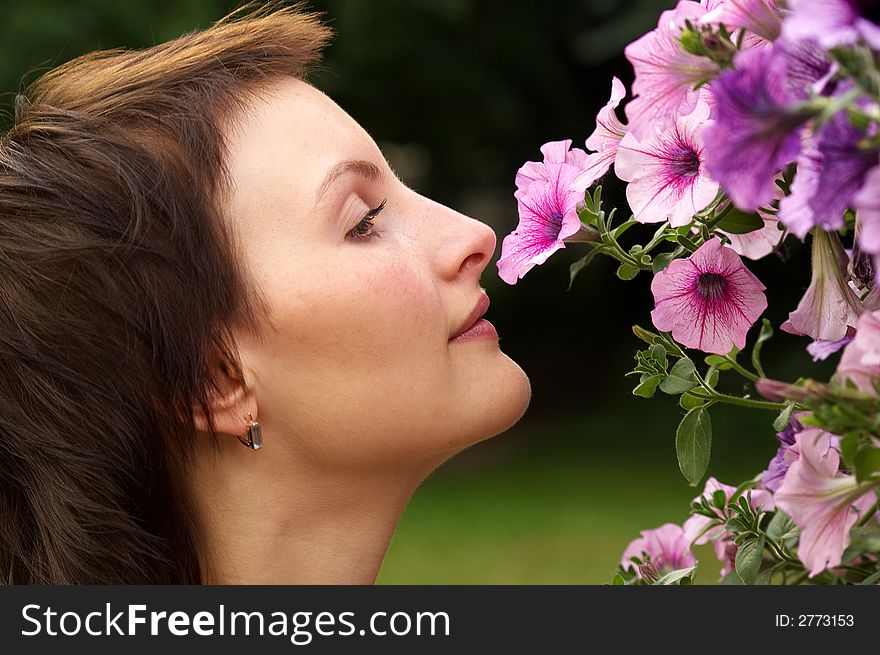 Young woman smelling a flower. Young woman smelling a flower