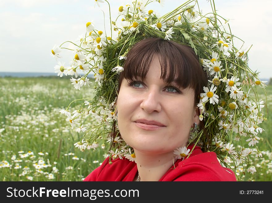 Portrait of young woman in a field of wild white daisies. Portrait of young woman in a field of wild white daisies