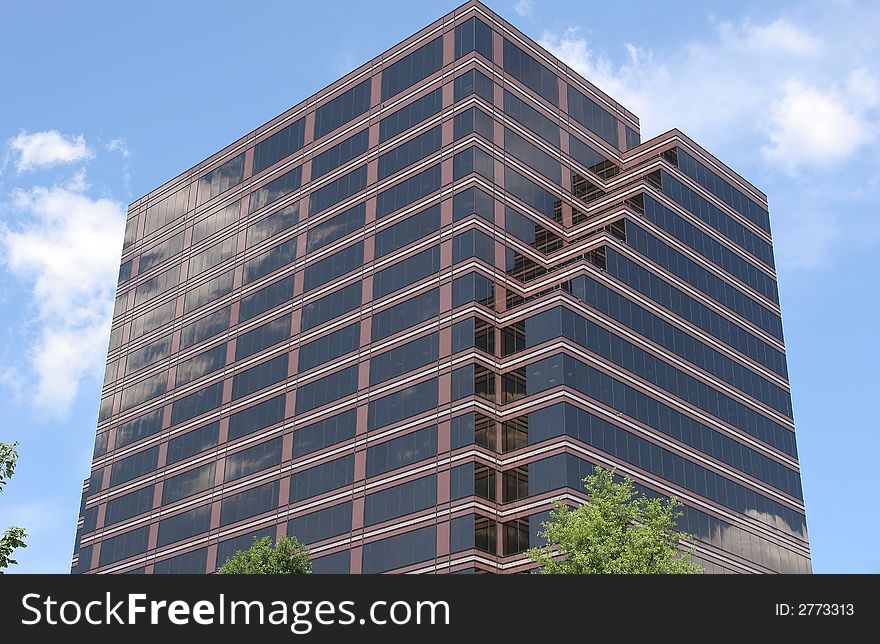 Brick and Glass Office Tower reflecting sky and clouds. Brick and Glass Office Tower reflecting sky and clouds