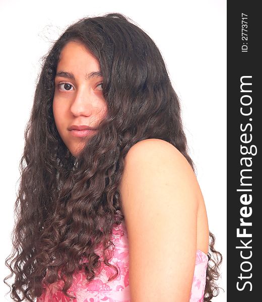 An portrait of a young teenager from the side and her
long curly hair hangs down, in a pink dress. On white background. An portrait of a young teenager from the side and her
long curly hair hangs down, in a pink dress. On white background.