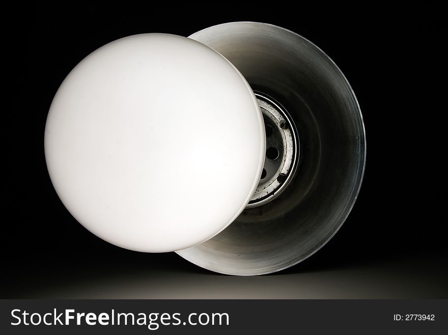 Glass circle light bulb on metal arm. Glass circle light bulb on metal arm