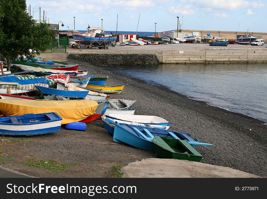 Fisherman boats on a black sand beach