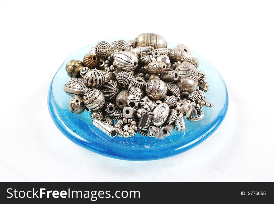 Beads and buttons isolated on white - craft supplies.