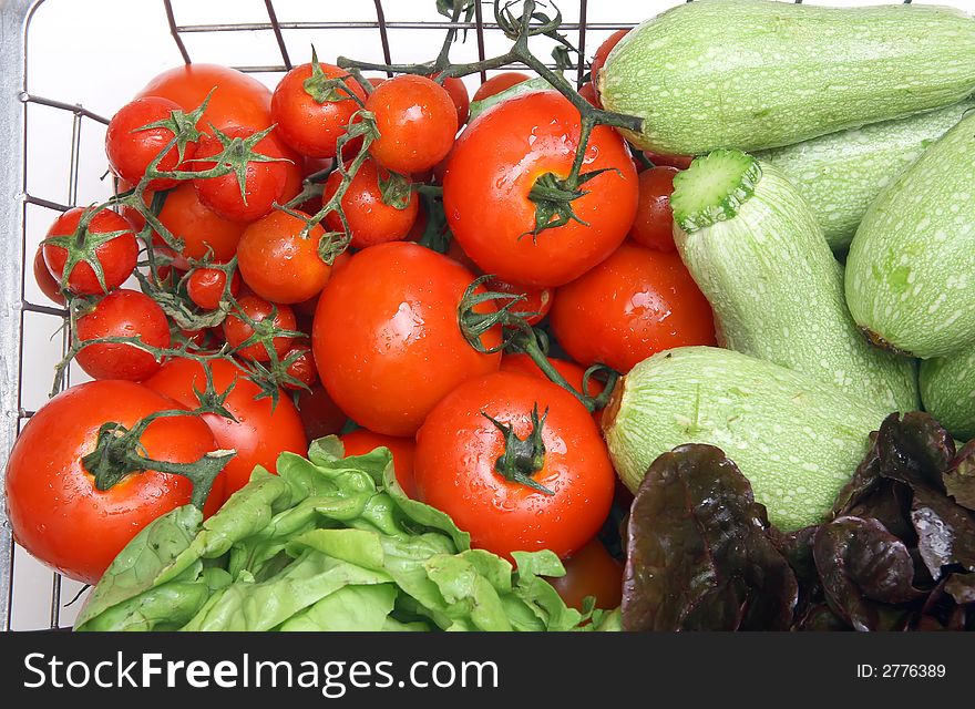 Diferents fresh vegetables on iron basket with drops