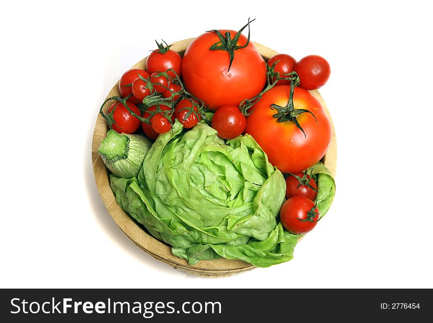 Diferents fresh vegetables on wooden basket with drops