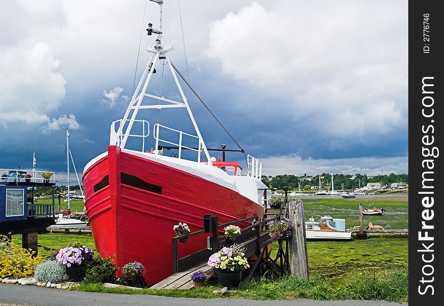 Red houseboat in dry tidal habor. Red houseboat in dry tidal habor