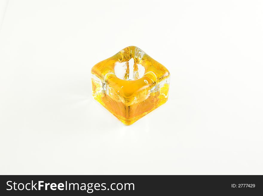 Yellow glazed candlestick on the white background