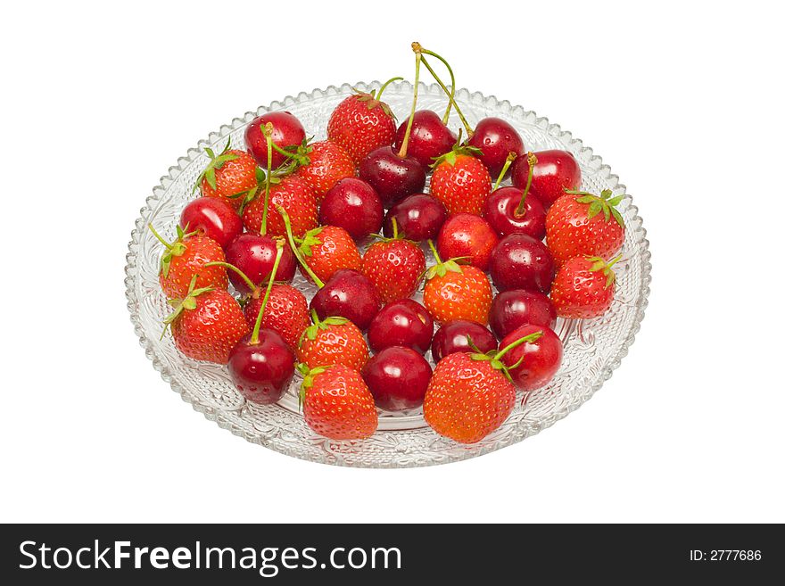 Strawberries and cherries on a glass dish, isolated on white background, with clipping path in the file. Strawberries and cherries on a glass dish, isolated on white background, with clipping path in the file