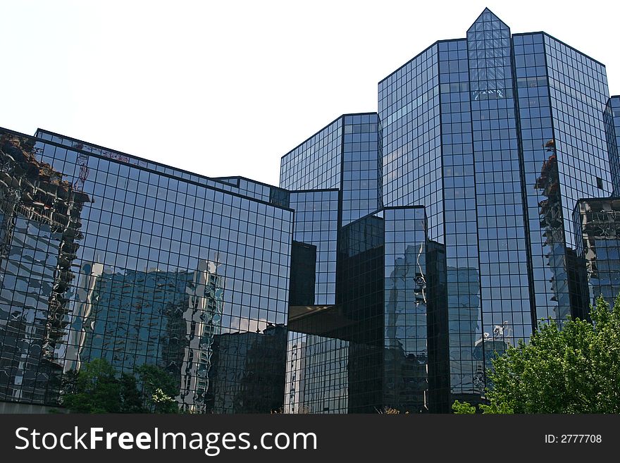 A blue glass financial center reflecting city. A blue glass financial center reflecting city