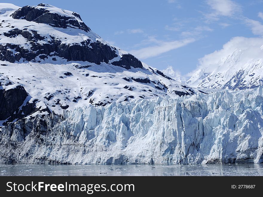 The blue glacier with a background of mountains in Glacier Bay national park, Alaska. The blue glacier with a background of mountains in Glacier Bay national park, Alaska.