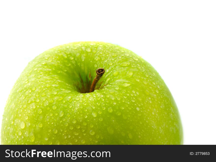 Big green apple covered  drop of water on  white background