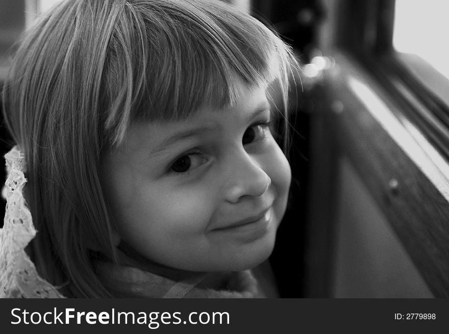 Smiling kid lighted from a bus window