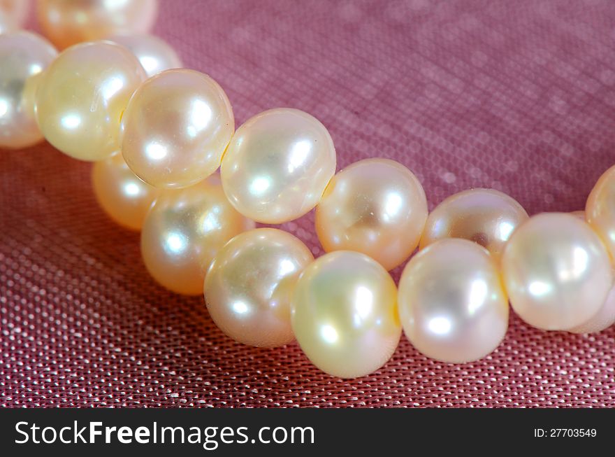 Pink pearls on pink satin background. Pink pearls on pink satin background.