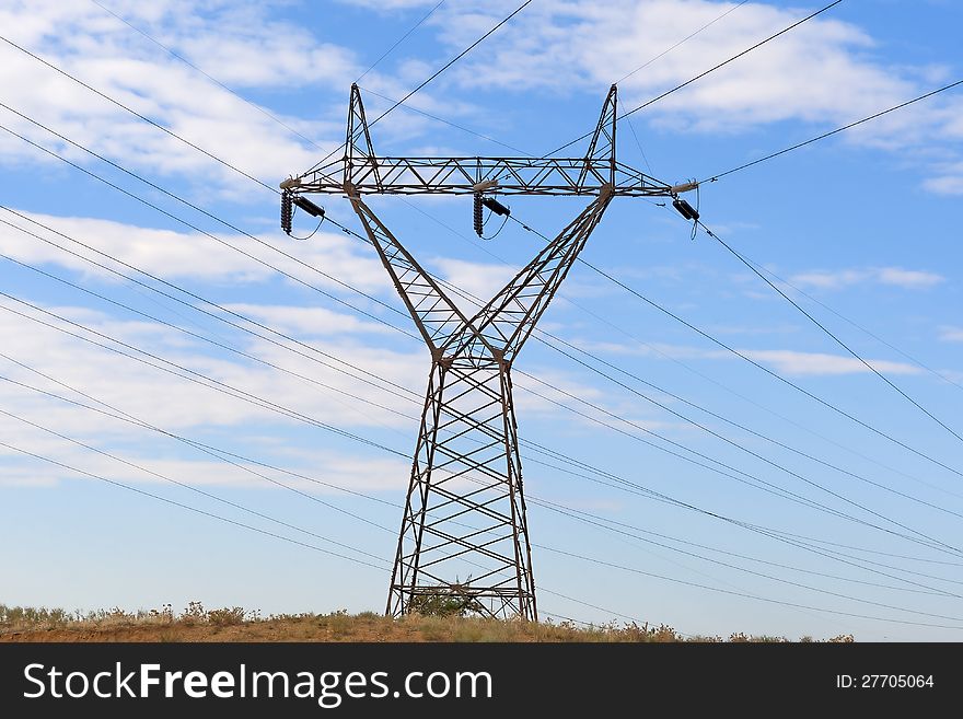 THESSALONIKI,GREECE - OCT,22 :High voltage electricity pillars in desert on the blue cloudy sky background on October 22, 2012 in Thessaloniki, Greece.