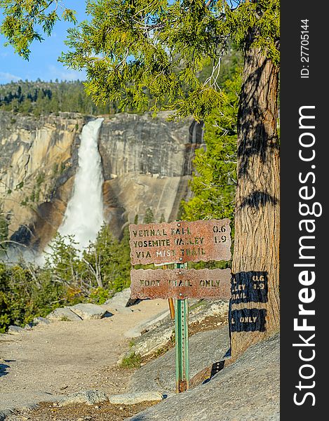 Tourist trail and sign and waterfall in Yosemite National Park. Tourist trail and sign and waterfall in Yosemite National Park