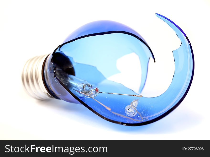 Broken blue light bulb on a white background. Broken blue light bulb on a white background