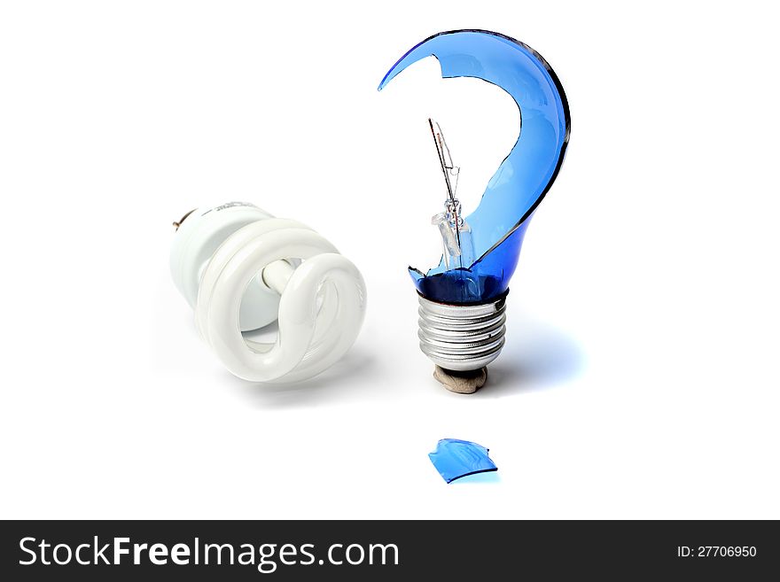 Broken light bulb in the form of a question mark next to a fluorescent bulb. Broken light bulb in the form of a question mark next to a fluorescent bulb