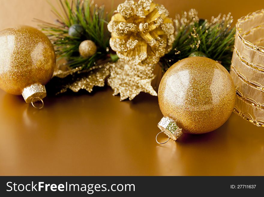 Golden christmas background with balls and pine cone
