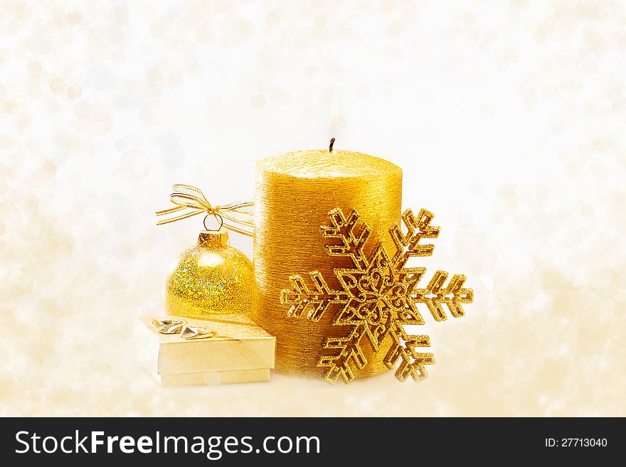 Winter holiday background with golden present gift box, candle ornament & Christmas snow decoration. Winter holiday background with golden present gift box, candle ornament & Christmas snow decoration