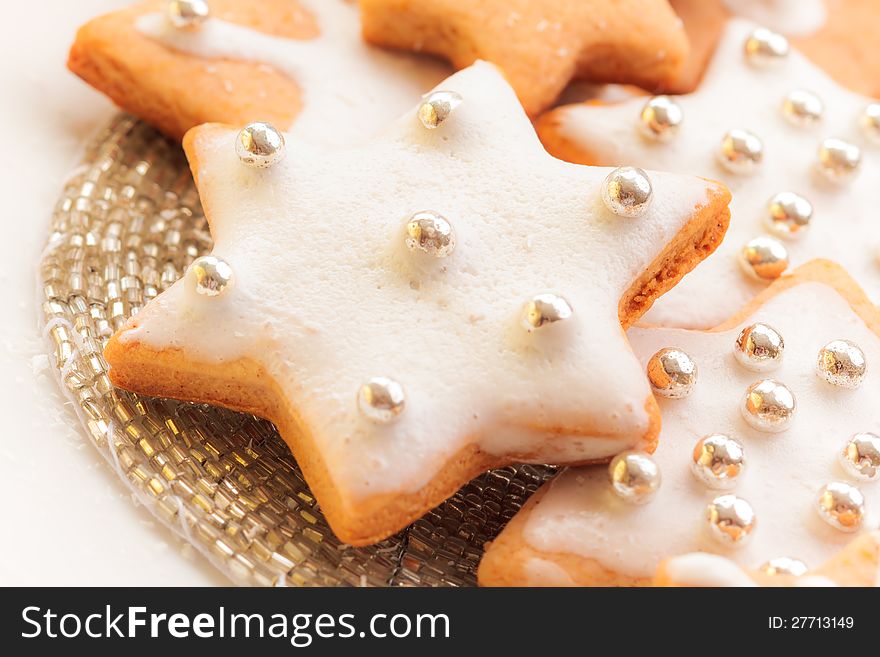 Typical christmas cinnamon star cookies with silver decoration. Typical christmas cinnamon star cookies with silver decoration