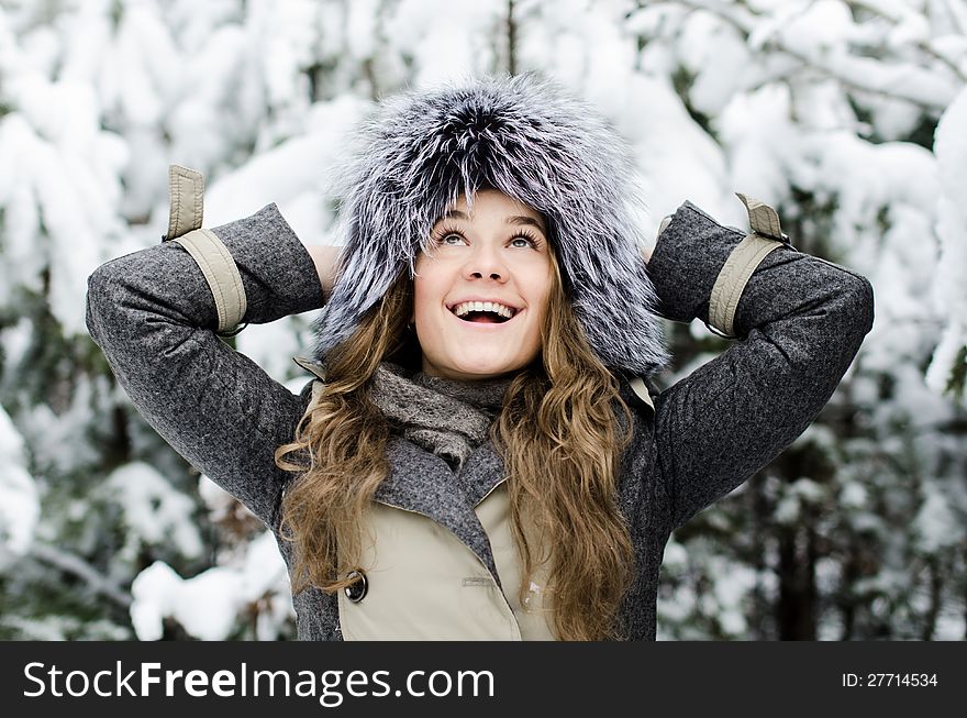 Smiling female in fure hat at the winter forest. Smiling female in fure hat at the winter forest