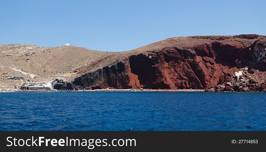 Akrotiri, Santorini, Greece. The Red Beach in Santorini filled with tourists. Akrotiri, Santorini, Greece. The Red Beach in Santorini filled with tourists.