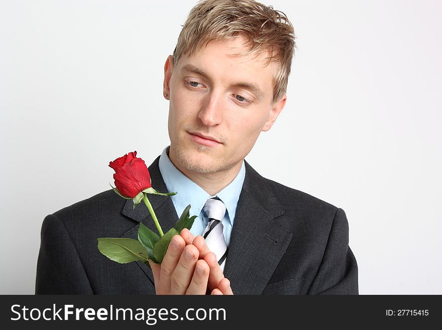 Portrait of a young man with a red rose. Portrait of a young man with a red rose
