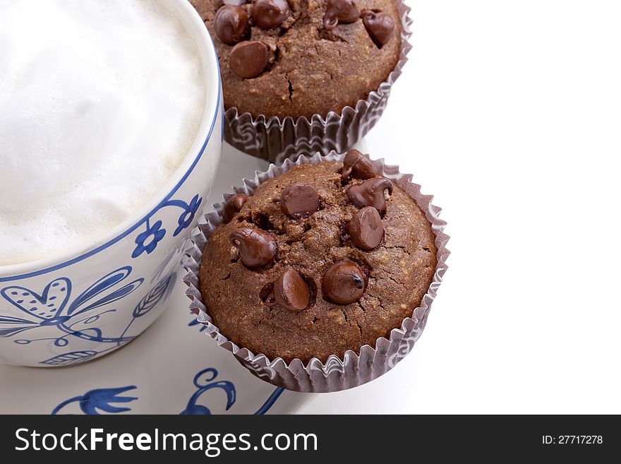 Fresh chocolate chip muffins with coffee cup, isolated on white background. Fresh chocolate chip muffins with coffee cup, isolated on white background