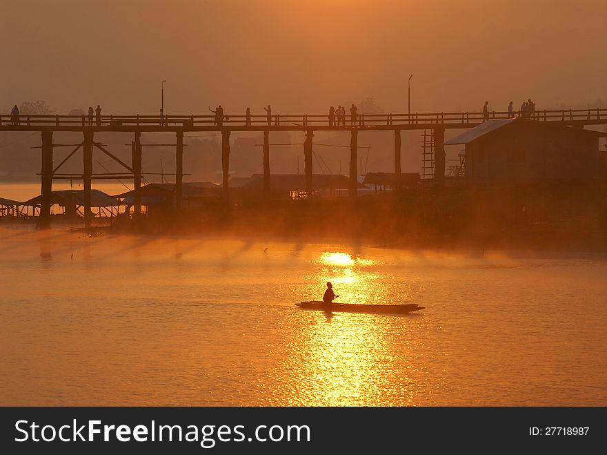 Wooden bridge in the morning.Bridge of the Mon.Sam pra sob river.Sanbkhlaburi Kanchanaburi Thailand. Wooden bridge in the morning.Bridge of the Mon.Sam pra sob river.Sanbkhlaburi Kanchanaburi Thailand.